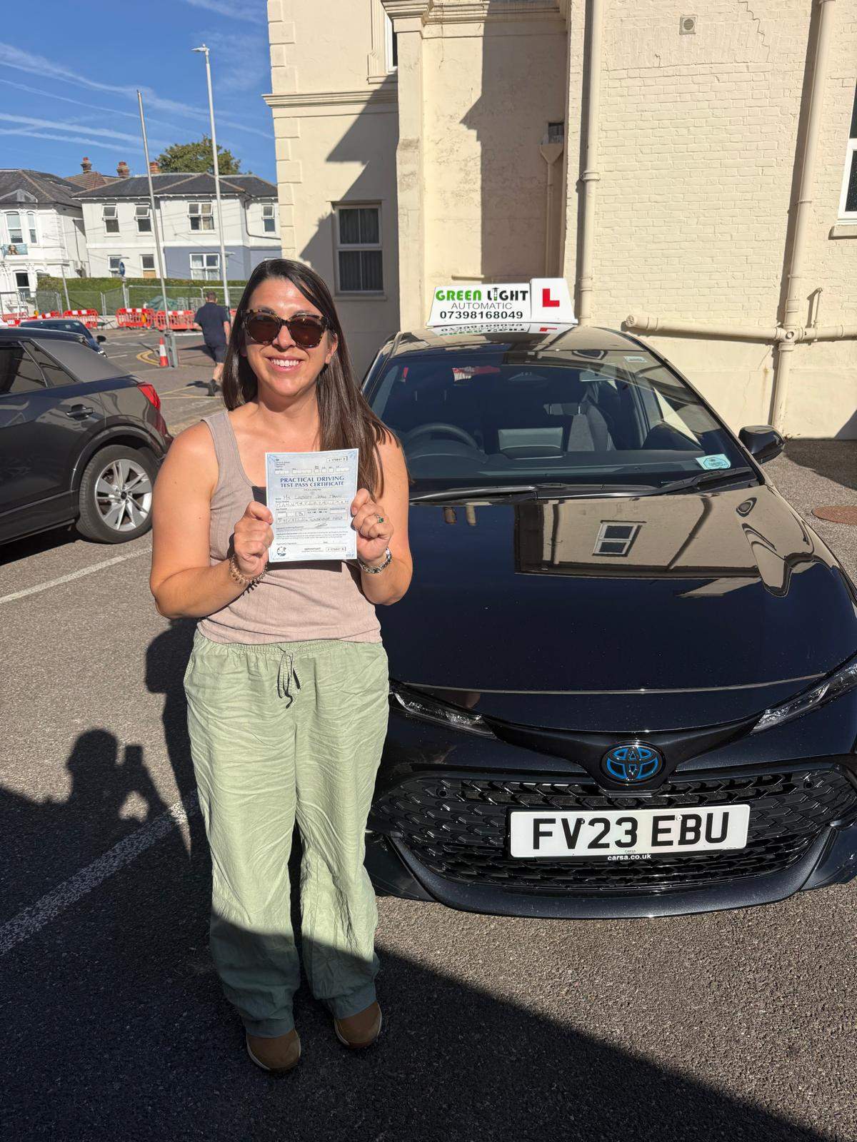 Learner holding a pass certificate